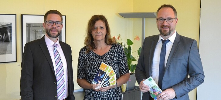 Landrat Thorsten Stolz (links) und Amtsleiter Matthias Schmitt (rechts) gratulieren der neuen Kulturbeauftragten Andrea Sandow zum neuen Verantwortungsbereich.